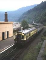 The afternoon train from Kyle to Inverness pulls out of the once-imposing station at Stromeferry in the summer of 1983. Attached at the rear of the train is ex-GWR coach no 9004 which was used as an observation coach on the line during the summer in the early 1980s. <br><br>[Frank Spaven Collection (Courtesy David Spaven) //1983]