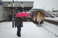 The morning of Monday December 6th 2010 saw all forms of transport in Central Scotland seriously disrupted through a combination of heavy snow and plunging temperatures. This photo was taken at Stirling on that day when conditions were rapidly deteriorating and almost all services were being either cancelled or abandoned. An exception was the 9.51 Alloa to Glasgow Queen Street, shown here battling through to collect passengers prepared to face an uncertain future.  What Class 156 DMUs lack in style and comfort, they make up for in ruggedness, weight and endurance, and this unit managed to take on the weather and get through to its destination.<br><br>[Mark Dufton 06/12/2010]