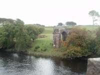 The surviving southern stump of the Tongland Viaduct, on the Kirkudbright branch, as seen from the nearby road bridge. Nature has softened the landscape around the structure in the last few years [See image 6002] although the pile of rubble is still in the field. Call me pessimistic but I have a feeling this is one Scottish line that will not be re-opening. <br><br>[Mark Bartlett 19/09/2010]