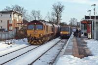 Hunterston bound coal empties hauled by 66 062 pass a morning Alloa to Glasgow Queen Street service awaiting departure time at Alloa on 11th December 2010.<br><br>[Mark Dufton 11/12/2010]