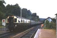 Platform view looking west as a train leaves Garve station for Kyle of Lochalsh in 1984. Bringing up the rear is ex-GWR coach no 9004, in use as an observation car on the line at that time.<br><br>[Colin Miller //1984]