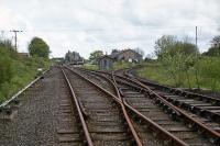 Following withdrawal of County School to Wroxham passenger trains in 1952, Reepham (GER) became a freight only terminus until lifted track was relaid to a new connection with the Norwich to Melton Constable line (M&GN) at Themelthorpe in 1960. Shown here are the (then) still open, but seldom used, sidings at Reepham in May 1977, looking east towards the station. In 2010, the station had become a pleasant caf, the goods shed a craft centre, and the trackbed a footpath/cycleway.<br><br>[Mark Dufton 15/05/1977]