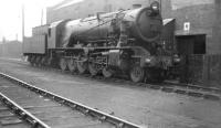 Longmoor Military Railway 2-10-0 no 601 <I>Kitchener</I> photographed on Kingmoor shed on 31 May 1958. The locomotive had been 'borrowed' by the Scottish Region in June 1957, primarily in connection with tests involving Ravenscraig iron ore workings using an air-braked locomotive. It had also been put to revenue earning use on various other freight workings during its stay. 601 entered the North British Works for overhaul in June 1958 emerging as an oil burner the following October.<br><br>[Robin Barbour Collection (Courtesy Bruce McCartney) 31/05/1958]