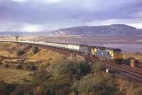 Two Type 2s attack the 1-in-60 gradient towards Culloden Moor on the eastern outskirts of Inverness in 1974. With at least 15 vehicles in tow - and no sign of sleeping cars or a restaurant car marshalled behind the locos - this is almost certainly the 16.30 Sunday train to Edinburgh and Glasgow.<br>
<br><br>[David Spaven //1974]