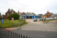 The 1875 station at Brotton (closed 1960) on the Cleveland Railway, looking across the High Street in October 2009. The main station building survives here as a tyre and exhaust centre, while the line itself handles considerable freight traffic operating between Teesside and Boulby/Skinningrove.<br><br>[John Furnevel 13/10/2009]