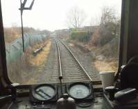 The disused platforms at Broadfield, closed in 1970, are seen from the rear of a Met Cam DMU heading for Heywood on the East Lancashire Railway. [See image 20996] for a view of Broadfield in 1968. The former goods yard is now occupied by housing that reaches right up to the old platforms, hence the trimmed hedge on the right hand side of the line. <br><br>[Mark Bartlett 01/01/2011]