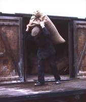 The way it used to be. Offloading sacks of malt from rail vans at Tain good yard in 1974, ready for delivery by NCL lorry to Glenmorangie distillery. The photographer - who was working on the railway in his student holidays - will not forget the ensuing trip to the distillery to help the lorry driver offload the malt. Job completed, the two were ushered into the bowels of the distillery, an official unlocked a tall cupboard and then ceremoniously poured each of them an exceedingly large dram. This was the generous practice afforded to all delivery men in those distant days!<br><br>[David Spaven //1974]