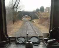 The remains of Ewood Bridge and Edenfield station, as seen from the rear of a passing ELR DMU heading for Bury. The station closed in 1972, with the Rawtenstall line, and in the preservation era has been replaced by Irwell Vale some distance to the south with the single line being slewed into the centre of the trackbed. [See image 19139] for a picture of the station immediately before closure. <br><br>[Mark Bartlett 01/01/2011]