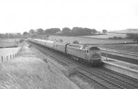 Happy days at Filey Holiday Camp in the summer of 1970. Class 47 no 1543 is awaiting departure from platform 4 on Saturday 15 August with train 1N60, the 10.20 to Newcastle. Standing on the station concourse in the left background is one of the Butlins <I>road-trains</I> used to ferry passengers between the station and the camp itself via a private tunnel under the A165 road. [See image 26824]<br><br>[Bill Jamieson 15/08/1970]