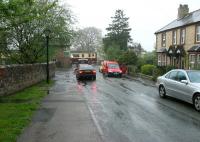 View north towards the signal box and level crossing in the village of Great Corby, North Cumbria, during a wet afternoon on 12 May 2006. A Stranraer Harbour - Newcastle Central DMU is heading east over the crossing having just left Wetheral Viaduct [see image 32749].<br><br>[John Furnevel 12/05/2006]