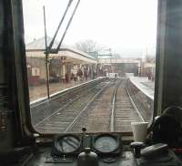 View from the rear of a DMU departing from the restored station at Ramsbottom on a service to Bury. The crossing gates are opening to road traffic after the departure of a <I>Black 5</I> hauled train for Rawtenstall. The DMU'S rev counter indicates the driver is just selecting second gear.<br><br>[Mark Bartlett 01/01/2011]