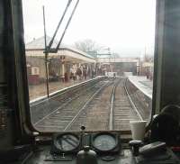 View from the rear of a DMU departing from the restored station at Ramsbottom on a service to Bury. The crossing gates are opening to road traffic after the departure of a <I>Black 5</I> hauled train for Rawtenstall. The DMU'S rev counter indicates the driver is just selecting second gear.<br><br>[Mark Bartlett 01/01/2011]