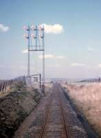Double-take time! Newmachar's signal test gantry seen from the brake van of the daily Fraserburgh-Aberdeen goods on 27th March 1973.<br>
<br><br>[David Spaven 27/03/1973]