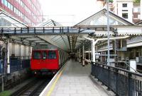 A District Line train stands in the platform 3 bay at High Street Kensington in July 2005, shortly after arriving with a shuttle service from Olympia.<br><br>[John Furnevel 24/07/2005]