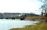 A short passenger train headed by a Black 5 coasts across Loch Ken viaduct, between Castle Douglas and New Galloway, two months before complete closure of the Dumfries - Stranraer <I>Port Road</I> in June 1965.<br><br>[Frank Spaven Collection (Courtesy David Spaven) /06/1965]