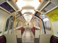 The maroon upholstery and orange grab-poles of this Glasgow Subway car give it away as one of the central trailer cars introduced in 1992 to make all trains three cars long (and filling the platforms). Colours aside the interior fittings are identical in appearance to the 1979 driving cars [see image 30788]. This is probably deliberate. Photographed on an eerily quiet system early on 4 January, a Scottish public holiday.<br>
<br><br>[David Panton 04/01/2011]