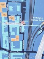 As the red 'You are Here' marker indicates, this new (January 2011) location-finder is situated outside Rutherglen station, but railways figure strongly with a nicely detailed diagram of Rutherglen Central Junction. Also featuring (top right) is the platform on the main line, even though it was last used in 1979, is understandably not in tip-top condition [see image 24526] and has no access. Farmeloan road is correctly spelled, unlike on the standard map in the station itself where it's shown as 'Frameloan' Road.<br><br>[David Panton 04/01/2011]