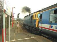 A class 33 locomotive departs from Tisbury, Wiltshire, on the single-line section between Templecombe and Salisbury, with an up train for Waterloo (accompanied by plenty of exhaust) in February 1992.<br><br>[John McIntyre 27/02/1992]