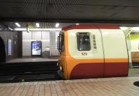 As a circular network the Glasgow Subway needs somewhere for recovery time, otherwise things can get in a mess due to the knock-on effect of just one delayed train. The station used is Govan. The driver of this unit on 4 January has taken advantage of the few minutes' stop to nip out. The livery is a combination of the once ubiquitous Strathclyde Red (orange to you and me) and SPT maroon and cream. Although surface trains are gradually being painted out of SPT livery the colours still belong to SPT and I can't see the Subway livery changing anytime soon.It's certainly unthinkable that the trains shouldn't sport at least some orange!<br><br>[David Panton 04/01/2011]