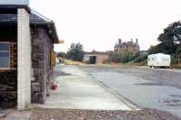 View from the Stranraer platform looking west at Castle Douglas in September 1973, some 8 years after closure. The trackbed has been infilled and one building remains at this stage (as a toilet block?). The former railway land here, which was put to a number of subsequent uses, is now occupied by a Tesco supermarket and its associated car park.<br><br>[Colin Miller /09/1973]