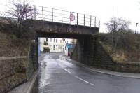 The overbridge on the Rosyth Dockyard branch, situated just to the <br>
north of Naval Base Junction where the lines to the Dockyard and North Queensferry pier parted company. The building in the background is the former Naval Base Mansions, now a kitchen and bathroom showroom. This is possibly the only example in history of flats being converted into a warehouse, which must really annoy estate agents. Another good way is...<br>
<br><br>[David Panton 16/01/2011]