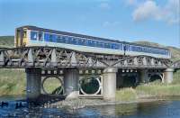 A southbound <i>Super Sprinter</i> crosses Earn Viaduct at Forgandenny during the long hot summer of 1990. This is what the viaduct looks like at low water. (Incidentally is that the remains of the original timber viaduct just peeping out of the riverbed on the left?)<br><br>[Ewan Crawford //1990]