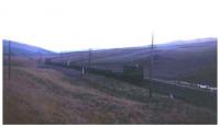 A class 08 hauled track recovery train rumbles north in rapidly fading light towards Falahill Summit in this rare January 1972 view, photographed during the penultimate phase of track lifting along the Waverley Route. <br><br>[David Spaven /01/1972]