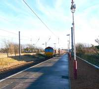 View south east along the platform at Ardrossan South Beach on 19 January 2011 as DBS 66054 approaches with train 4J06 Longannet empties destined for Hunterston HL sidings.<br><br>[Ken Browne 19/01/2011]