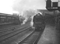 A dismal-looking day at the south end of Carlisle on 28 December 1963 sees activity at platforms 3 & 4, with a pair of  Stanier Pacifics having recently taken over WCML trains for the south. On the left no 46237 <I>City of Bristol</I>  prepares to take out the up <I>Royal Scot</I> while on the right no 46240 <I>City of Coventry</I> has just backed onto an Edinburgh Waverley - Birmingham New Street service.<br>
<br><br>[Robin Barbour Collection (Courtesy Bruce McCartney) 28/12/1963]