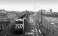 An MGR train is being loaded with stockpiled coal at the closed Seaham Collieryin 1991. A class 56 is at the far end and a 20T brake van is provided, given the propelling movement required back to the main line.<br>
<br><br>[Bill Roberton //1991]