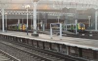 The majority of outer suburban services at Euston are now handled by the Class 350 <I>Desiro</I> units and the London Midland black/grey/green livery is quite striking, particularly the black window surrounds that make the windows appear huge. 350245 and 350123 are at the head of twelve coach trains at Euston at the end of the morning rush hour.<br><br>[Mark Bartlett 18/01/2011]