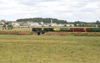 A pair of Freightliner class 86 locomotives heading north along the WCML with the Crewe - Coatbridge containers in July 2007. The train is on the southern approach to Carstairs station with the State Hospital dominating the background.<br><br>[John Furnevel 31/07/2007]