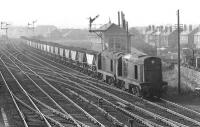 A pair of class 20s with an MGR coal train from the Fife coalfield to Cockenzie PS passing Saughton Junction box in March 1972. Unusually both locomotives arerunning 'smokebox first' - presumably there had been a failure and thereplacement could not be turned for them to be coupled with thecabs facing outwards as was normal practice.<br><br>[Bill Jamieson /03/1972]