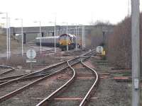 DBS 66041 waits in Killmarnock Long Lyes after running round for a journey to Greenburn from Drax PS on 26 January. The line to the right of the train leads north to Kilmaurs, Stewarton and Glasgow Central.<br><br>[Ken Browne 26/01/2011]