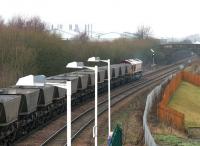 Westbound coal empties returning from Longannet to Hunterston rumble west through Camelon station, Falkirk, on 10 December 2004. The train is signalled for the route west at Carmuirs East Junction, just beyond the bridge.<br><br>[John Furnevel 10/12/2004]