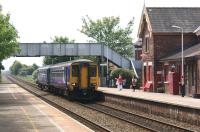 A Northern service from Blackpool North slows for the first <br>
stop on the journey to Manchester Victoria at Layton on 5 June 2010. The station building on the up platform still stands but is no longer in railway use.<br>
<br><br>[John McIntyre 05/06/2010]