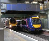 View west along platforms 19 and 20 on the north side of Waverley on 20 November 2010 with a service for Penzance at 19 and a Perth train at 20. The normal Waverley Steps exit to Princes Street, via the blue footbridge, will be closed from 10 February for modernisation with temporary access provided through Princes Mall using the bridge in the background. [See image 9662]<br><br>[David Panton 20/11/2010]