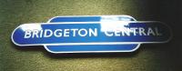 A totem from Bridgeton Central in fine condition. This Glasgow East <br>
End terminus spent only 11 years as Bridgeton Central, becoming plain Bridgeton following the closure in 1964 of Bridgeton Cross on the former Glasgow Central Railway. To confuse matters Bridgeton Central had once been called Bridgeton Cross too. The terminal 'Brigton' closed in 1979 on the opening of the Argyle Line - really the former GCR here - when the former Bridgeton Cross reopened taking over the name Bridgeton. I hope you are following this. The old terminus survived as a depot for a few years until the line was closed and the area redeveloped, but the station frontage remains [see image 14292].<br>
<br><br>[David Panton //]