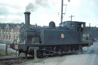 J88 0-6-0 no 68335 trundles over a level crossing in Gorgie East yard on 3rd April 1961. The station is off picture to the right and the front door of the Station Bar can be seen opposite the yard entrance on the north side of Gorgie Road in the right background.<br><br>[Frank Spaven Collection (Courtesy David Spaven) 03/04/1961]