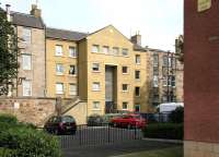 Odd one out, Easter Road, June 2006. View north west showing the rear of the modern flats  now filling the gap originally occupied by a tenement block demolished in 1901. The demolition took place to make way for the lines across Easter Road into the new Leith Central station. [See image 10105] for the view east from Leith Central. <br><br>[John Furnevel 23/06/2006]