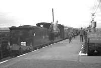 Platform scene at Whifflet Upper station on 9 June 1962, with enthusiasts hurrying to rejoin the SLS <I>Glasgow South Rail Tour</I>. [McIntosh 3F 0-6-0 no 57581 propelled the train on the Langloan Junction - Airdrie (Caledonian) section of the tour]. On the right is the stairway connecting the island platform with Whifflet Lower. [See image 10716]<br><br>[K A Gray 09/06/1962]