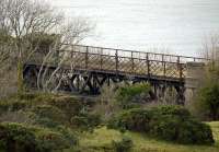 A surviving truss girder bridge spanning a burn south of Dunure on the former Maidens and Dunure Light Railway. Photographed on 8 February 2011.<br><br>[Colin Miller 08/02/2011]