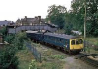 A Tuesday afternoon service to Marks Tey draws out of Sudbury station on 6th September 1977. The tall starting signal was later replaced by a shorter version nearer the signal box.<br><br>[Mark Dufton 06/09/1977]