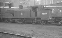 Withdrawn McIntosh 2P 0-4-4T no 55124 stands alongside Dalry Road shed in February 1962. View is south east with the tenements of Dundee Street forming the backdrop. Today (2011) the St Cuthbert's Co-op building beyond the locomotive is a large bathroom centre and the photographer would be standing on what is now Edinburgh's Western Approach Road.<br><br>[K A Gray 03/02/1962]