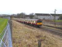 314 205 on the reversing stub at Neilston, just west of the station, in February 2011.On electrification in 1962 stabling was constructed behind the remaining track but it was removed 15 years <br>
later.That disused yard lamp appears to be a relic.[With thanks to <br>
Stewart Duthie for additional information.] <br>
<br><br>[David Panton 05/02/2011]