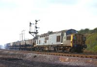 D6712 eases its load of empty coal hoppersdowngrade on the approach to South Pelaw Junction in September 1970. From the look of thesmoke the wagon brakes have been pinned down all the way fromConsett.<br><br>[Bill Jamieson 30/09/1970]