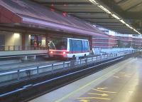 Choa Chu Kang station is where MRT (foreground) and LRT (background) meet in Singapore. The LRT system is in the shape of a bottle of Tia Maria, with a gift tag 'flying' from its neck. CCK station is at the top of the cork! The LRT cars run in ones or twos, and have rubber tyred wheels and a single, central guide rail which also supplies electricity at 600V AC. Nonetheless, a noisy air pump for the brakes makes the LRT cars sound like engine-driven vehicles. They are driverless, and have only peripheral seating, to allow for crush loading.<br><br>[Ken Strachan 28/01/2011]