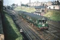 A North Berwick bound DMU runs past Craigentinny signal box on 24 September 1958. In the background a V1/V3 stands with an empty stock train from Waverley waiting to cross over into Craigentinny carriage sidings. <br><br>[A Snapper (Courtesy Bruce McCartney) 24/09/1958]