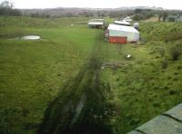 Looking North over the station site at Woodford Halse from the GC road overbridge in 2011. The link connecting with The S&MJ line ran off to the west just beyond the pond on the left. [See image 34070]<br><br>[Ken Strachan 04/02/2011]