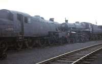 Scene at Carnforth in 1968, with newly rescued Fairburn LMS 4MT 2-6-4T 42085 and BR Standard 4MT 4-6-0 75027 stored on one of the shed roads. The tank engine would stay in the North West on the Lakeside and Haverthwaite Railway but 75027 was destined for the Bluebell Railway where it stilll operates. <br><br>[David Hindle //1968]